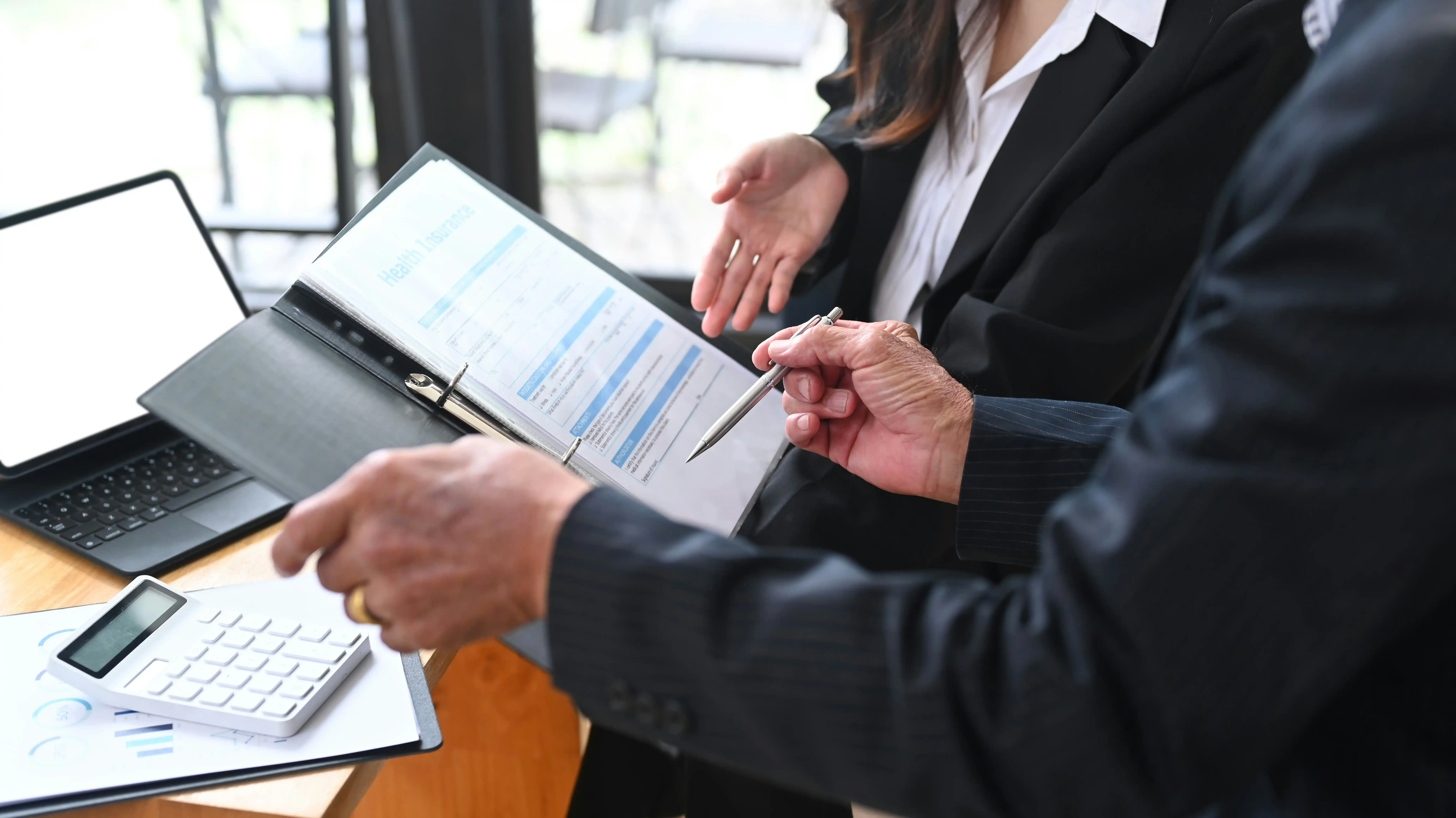 Manager konfrontiert Mitarbeiterin mit Verhalten auf Papier